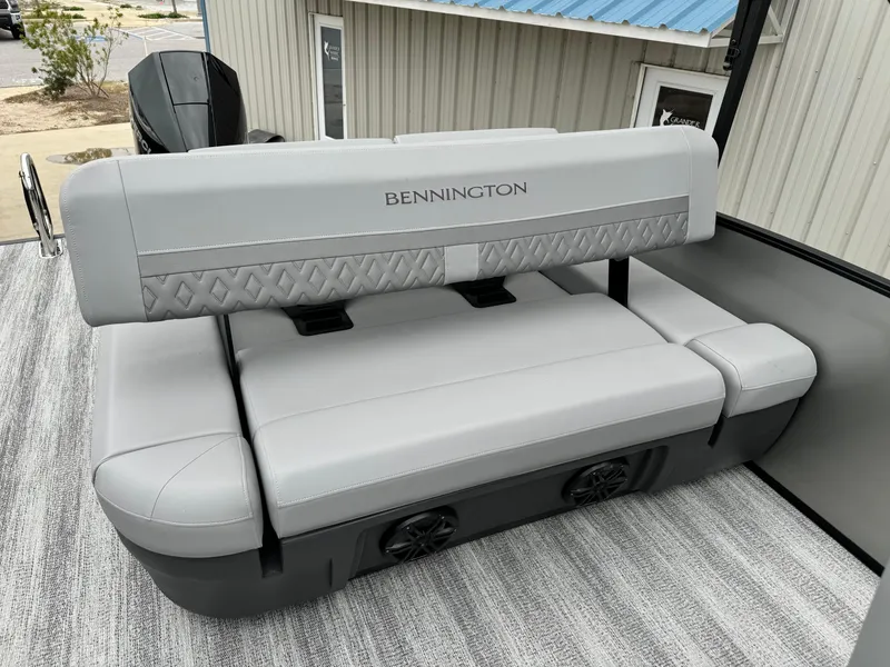 Slide: The Image of 2025 Bennington 22MSB boat seating with gray upholstery and integrated speakers. - 11