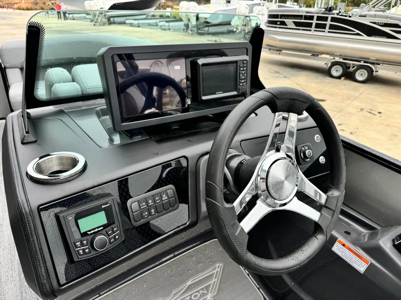 Slide: The Image of 2025 Bennington 22MSB boat dashboard with modern steering and digital controls. - 14