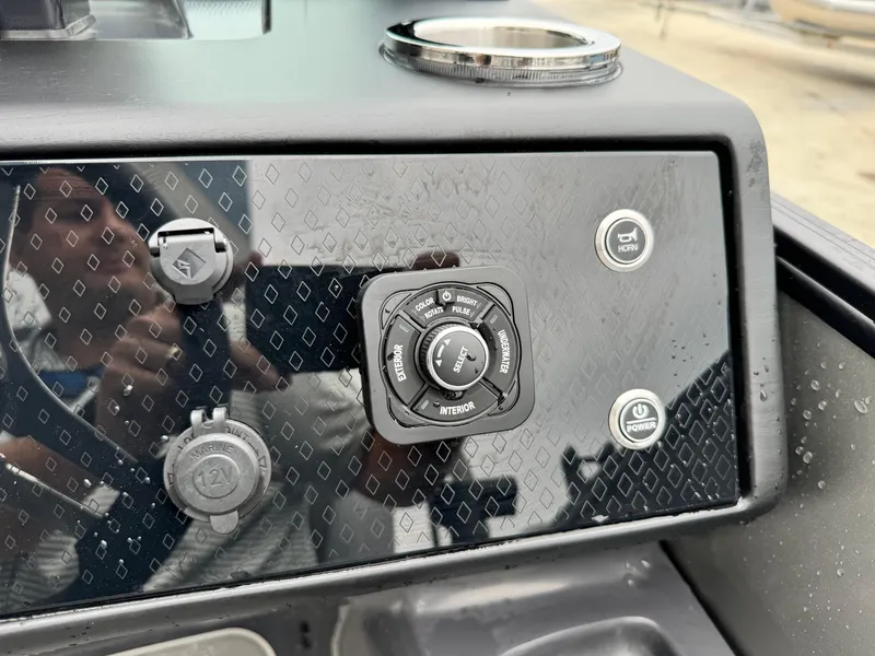 Slide: The Image of Control panel of 2025 Bennington 22MSB boat with various buttons and dials. - 16