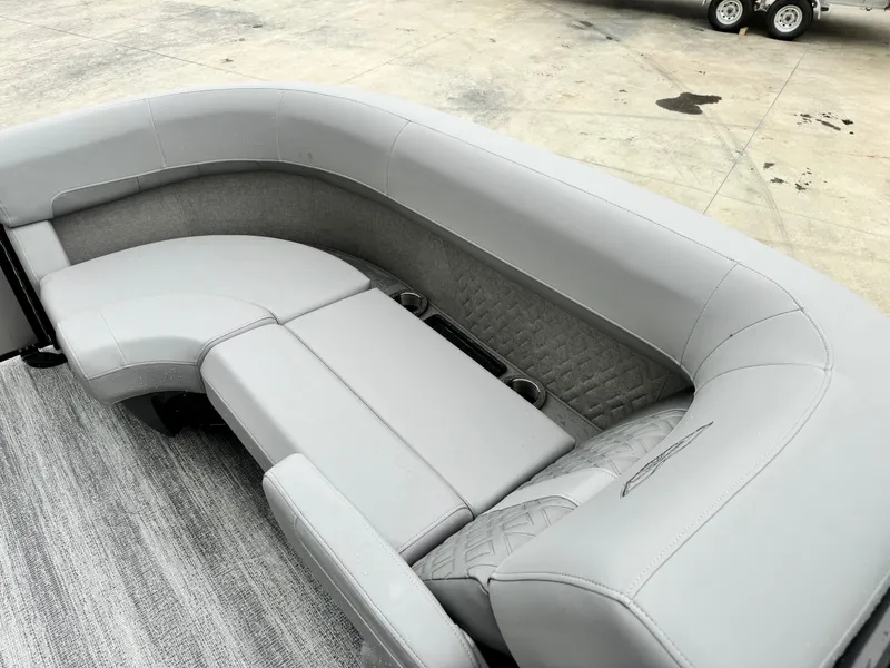 Slide: The Image of 2025 Bennington 22MSB boat interior with gray seating and cup holders. - 19