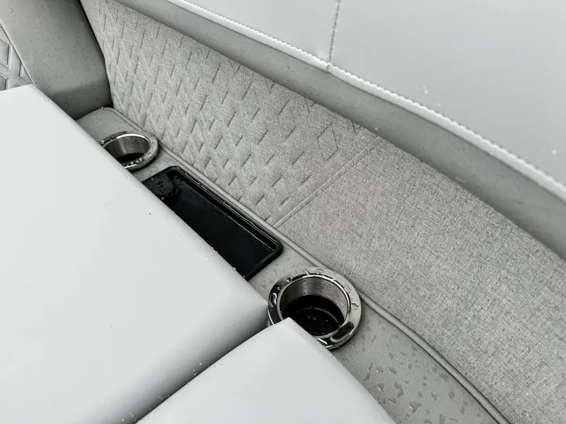 Slide: The Image of 2025 Bennington 22MSB boat interior with cup holders and textured upholstery. - 20