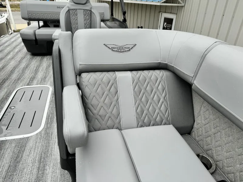 Slide: The Image of 2025 Bennington 22MSB boat interior with luxurious gray seating and diamond stitching. - 21
