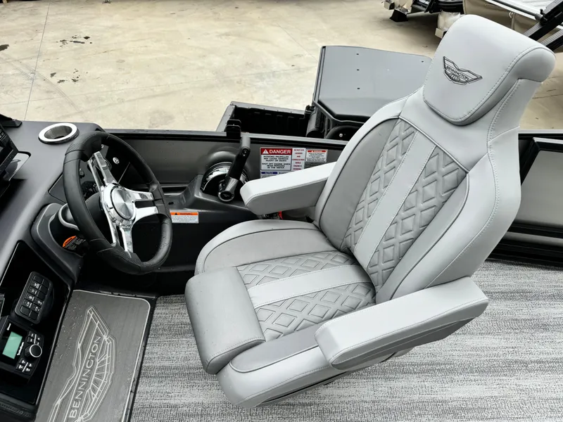 Slide: The Image of 2025 Bennington 22MSB boat interior with luxury captain's chair and steering console. - 27