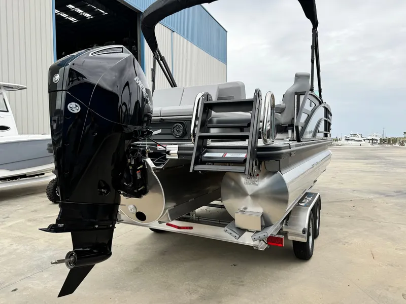 Slide: The Image of 2025 Bennington 22MSB pontoon boat on trailer, featuring powerful outboard motor. - 3