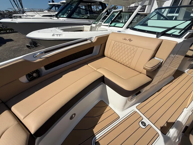 Slide: The Image of 2025 Sea Ray SLX 310 OB boat with luxurious tan seating and sleek design. - 19
