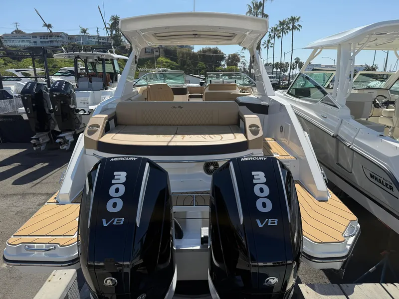 Slide: The Image of 2025 Sea Ray SLX 310 OB boat with dual Mercury 300 V8 engines docked at marina. - 4
