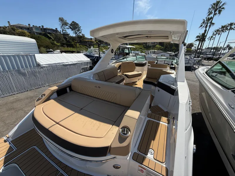 Slide: The Image of 2025 Sea Ray SLX 310 OB luxury boat with spacious seating and sleek design. - 5