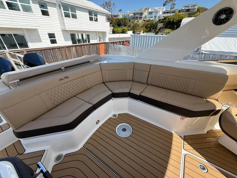 Slide: The Image of 2025 Sea Ray SLX 310 OB boat with luxurious tan seating and teak flooring. - 8