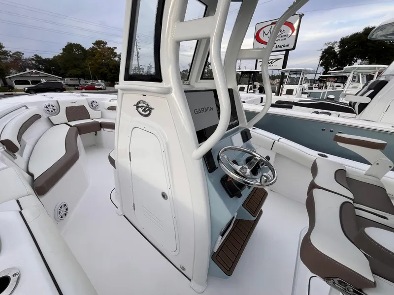 Slide: The Image of 2025 Tidewater 232 LXF boat interior with modern seating and steering console. - 14