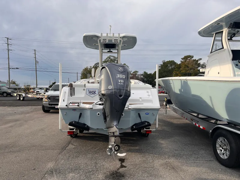 Slide: The Image of 2025 Tidewater 232 LXF boat with Yamaha 300 V6 engine in parking lot. - 4