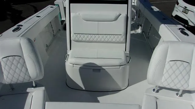 Slide: The Image of 2025 Sportsman Heritage 261 boat interior with white cushioned seating. - 11