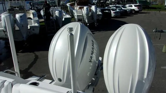 Slide: The Image of 2025 Sportsman Heritage 261 boat with Yamaha engines in a marina parking lot. - 17