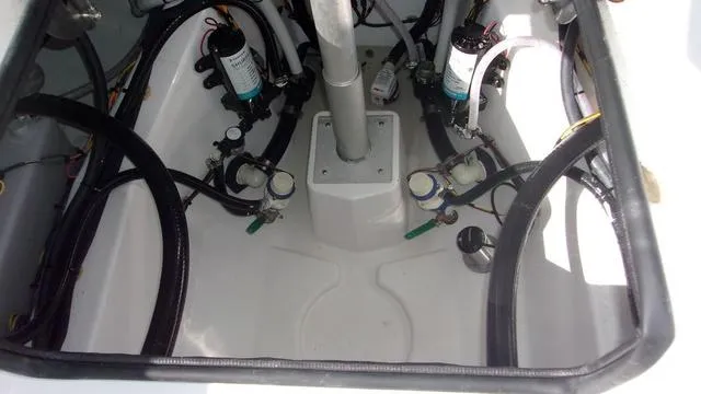 Slide: The Image of 2025 Sportsman Heritage 261 boat engine compartment with hoses and filters. - 18