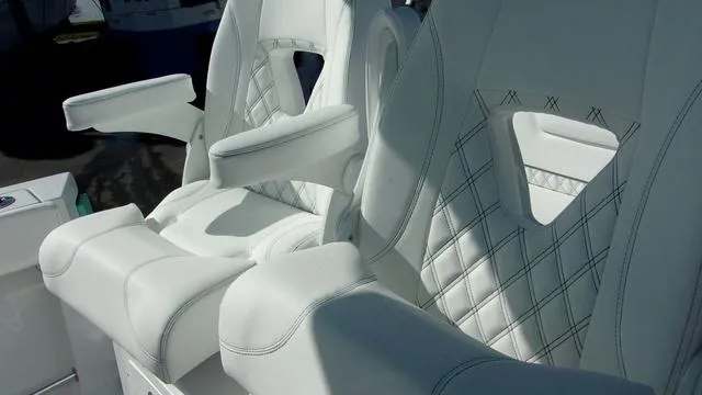 Slide: The Image of Luxurious white seating on 2025 Sportsman Heritage 261 boat, featuring elegant stitching. - 20