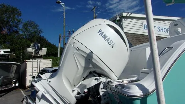 Slide: The Image of 2025 Sportsman Heritage 261 boat with Yamaha outboard motor in a marina setting. - 3