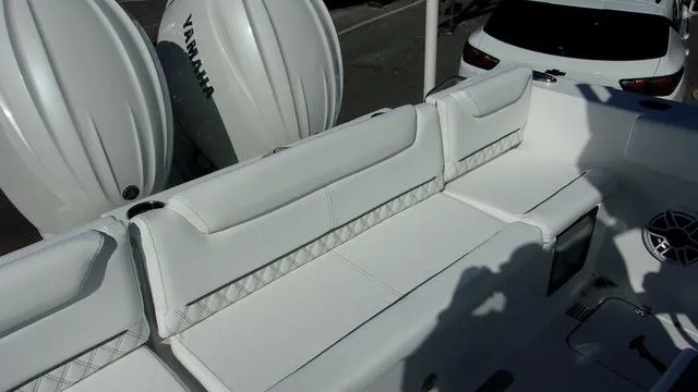 Slide: The Image of 2025 Sportsman Heritage 261 boat interior with white seating and Yamaha engines. - 6