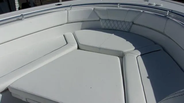 Slide: The Image of 2025 Sportsman Heritage 261 boat with white cushioned seating area. - 8
