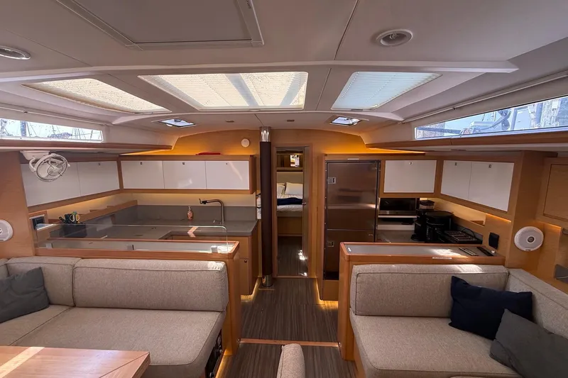 Slide: The Image of Luxurious interior of 2022 Dufour 530 yacht with modern kitchen and seating area. - 13