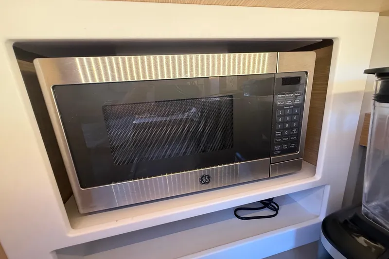 Slide: The Image of Built-in GE microwave in 2022 Dufour 530 yacht kitchen. - 26