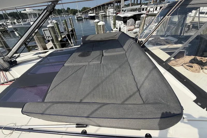 Slide: The Image of 2022 Dufour 530 yacht with spacious sunbathing area, docked at marina. - 39