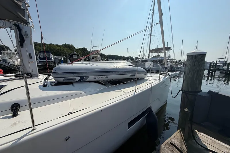 Slide: The Image of 2022 Dufour 530 yacht docked with inflatable boat on deck. - 4