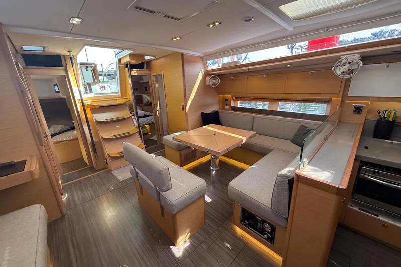 Slide: The Image of Luxurious interior of 2022 Dufour 530 yacht with modern seating and kitchen area. - 5