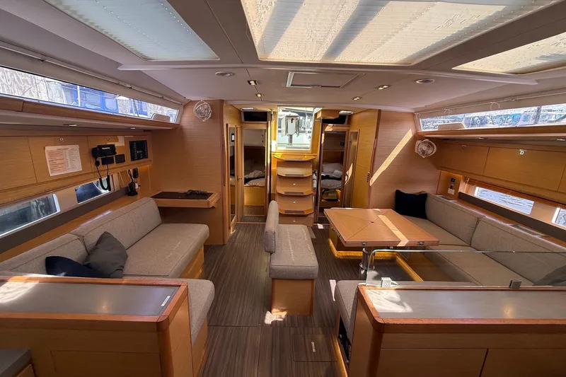 Slide: The Image of Luxurious interior of 2022 Dufour 530 yacht with modern furnishings and ample natural light. - 6