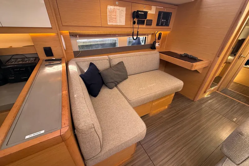 Slide: The Image of Modern interior of 2022 Dufour 530 yacht with cozy seating and wooden finishes. - 8