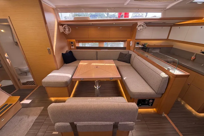 Slide: The Image of Luxurious interior of 2022 Dufour 530 yacht with modern seating and dining area. - 9