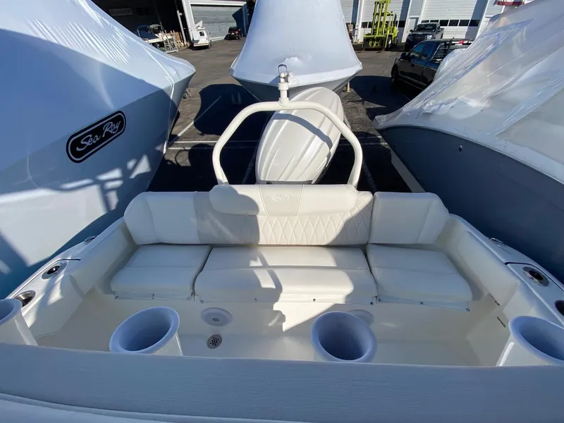 Slide: The Image of 2025 Key West 219 FS boat interior with white seating and cup holders. - 10