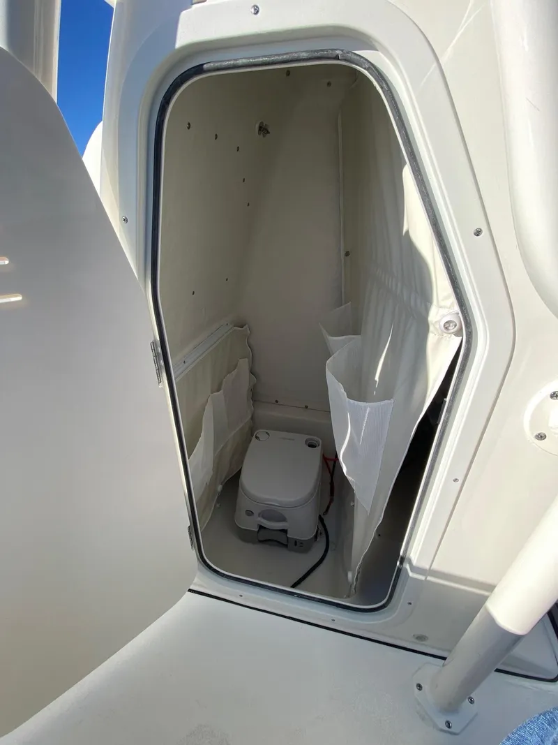 Slide: The Image of 2025 Key West 219 FS boat interior with compact marine toilet. - 13