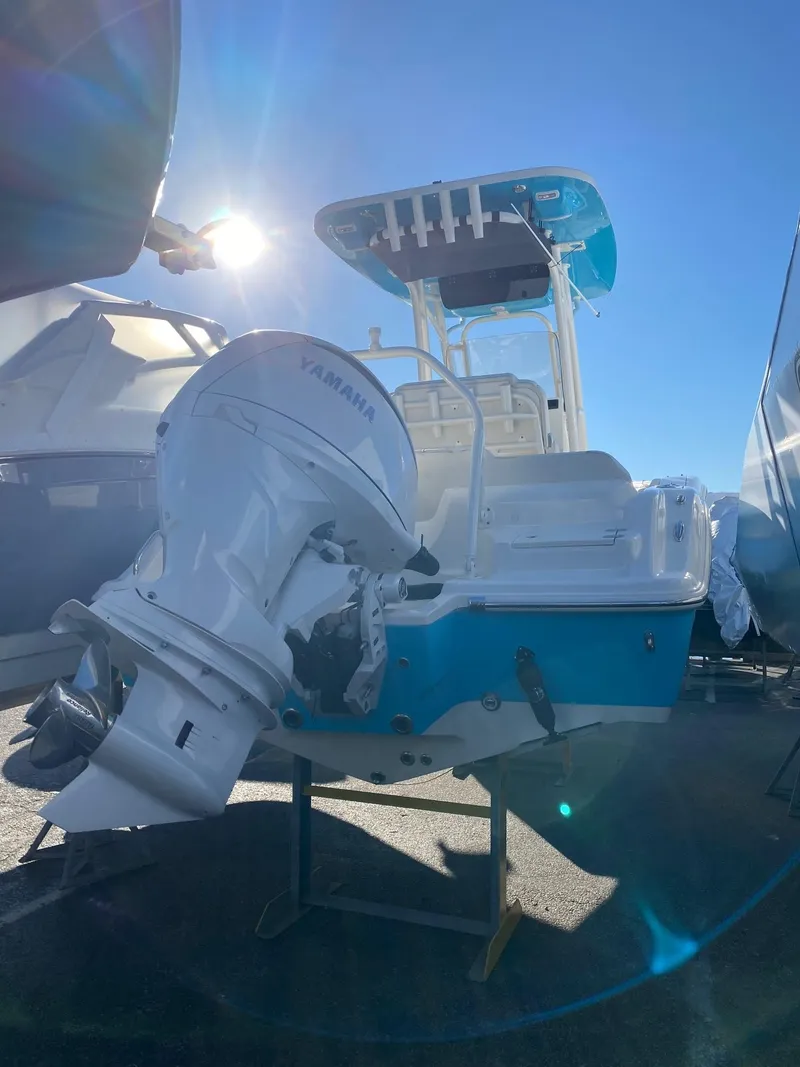 Slide: The Image of 2025 Key West 219 FS boat with Yamaha outboard motor under bright sunlight. - 2