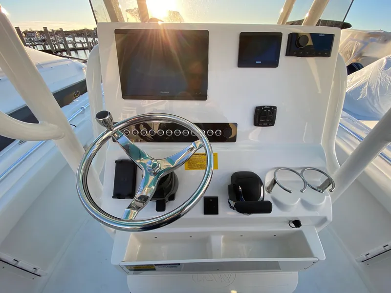 Slide: The Image of 2025 Key West 219 FS boat console with steering wheel and electronic displays. - 3