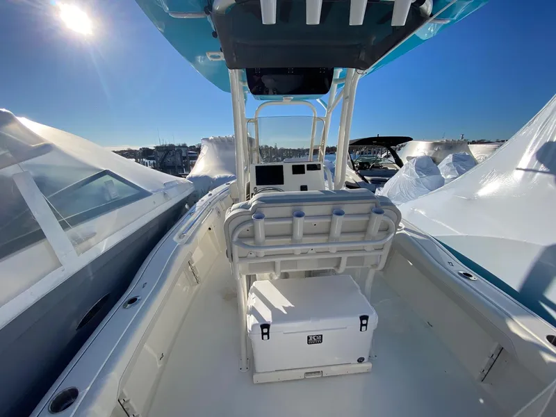 Slide: The Image of 2025 Key West 219 FS boat interior with console and seating, under clear blue sky. - 6