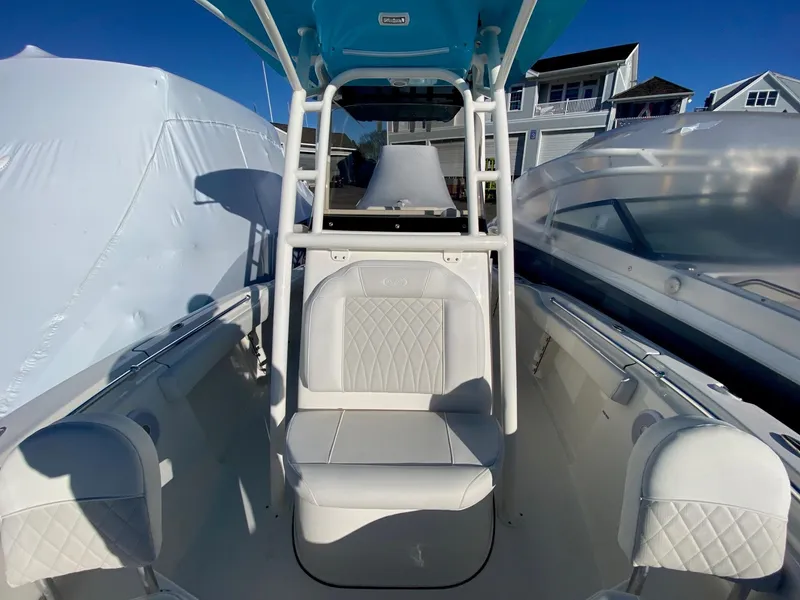 Slide: The Image of 2025 Key West 219 FS boat interior with white seating and blue canopy. - 7