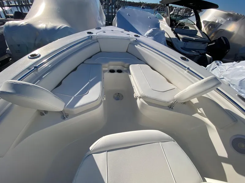 Slide: The Image of 2025 Key West 219 FS boat interior with white seating and modern design. - 9
