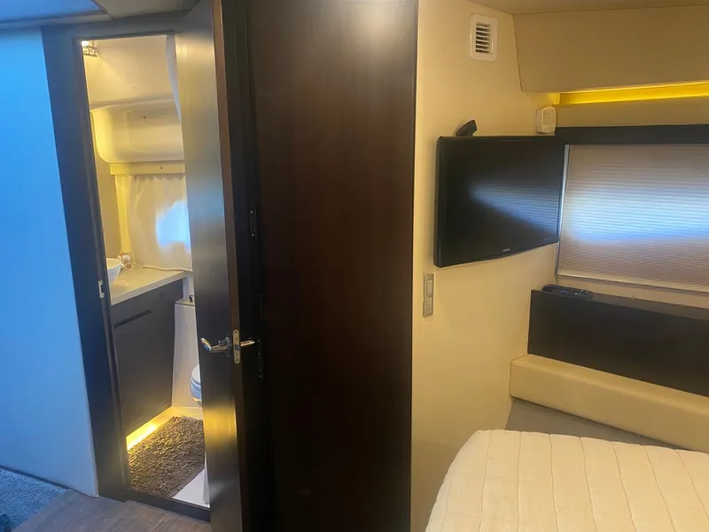 Slide: The Image of Interior of 2018 Regal 42 Fly yacht, featuring a cozy bedroom and modern bathroom. - 13
