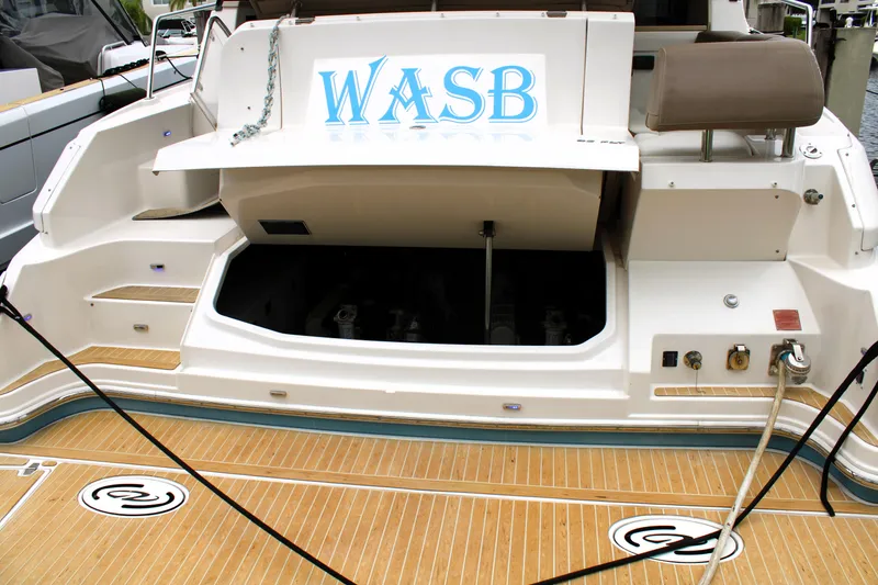Slide: The Image of Regal 42 Fly 2018 yacht stern with open engine compartment and teak deck. - 17