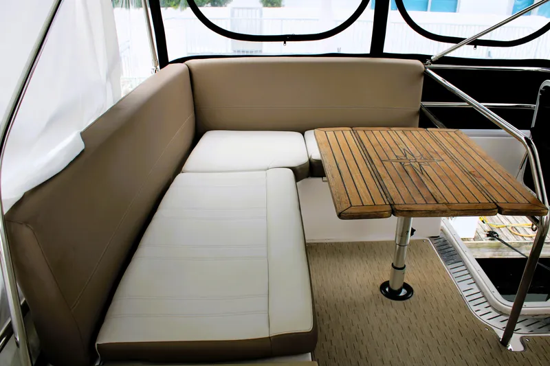 Slide: The Image of Luxurious seating area on 2018 Regal 42 Fly yacht with wooden table. - 20