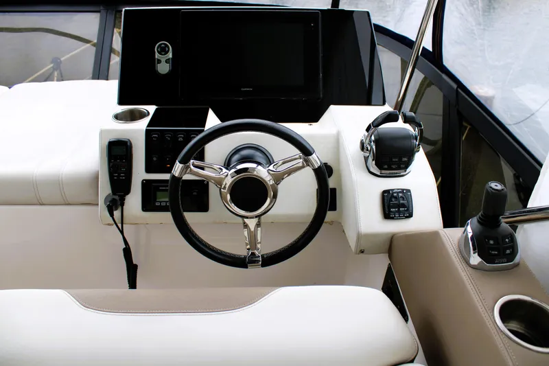 Slide: The Image of Steering console of 2018 Regal 42 Fly yacht with modern controls and navigation equipment. - 21