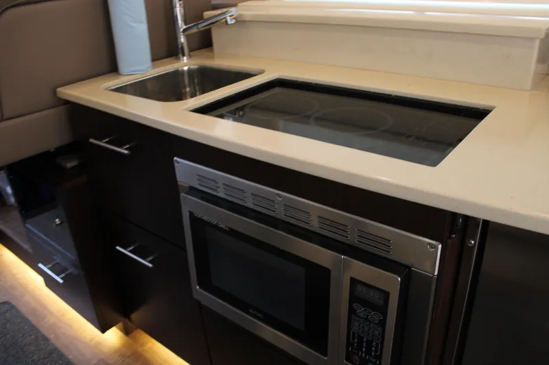 Slide: The Image of Modern kitchen area in 2018 Regal 42 Fly yacht with sink and microwave. - 23