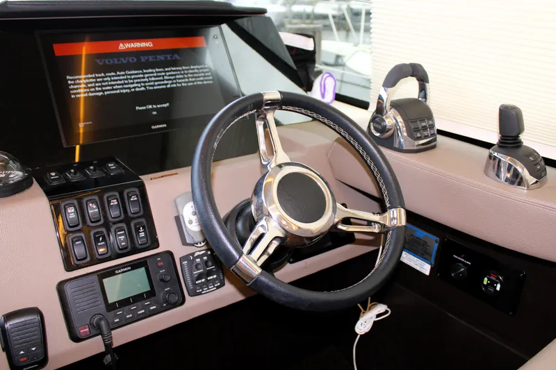 Slide: The Image of 2018 Regal 42 Fly yacht helm with advanced controls and steering wheel. - 25