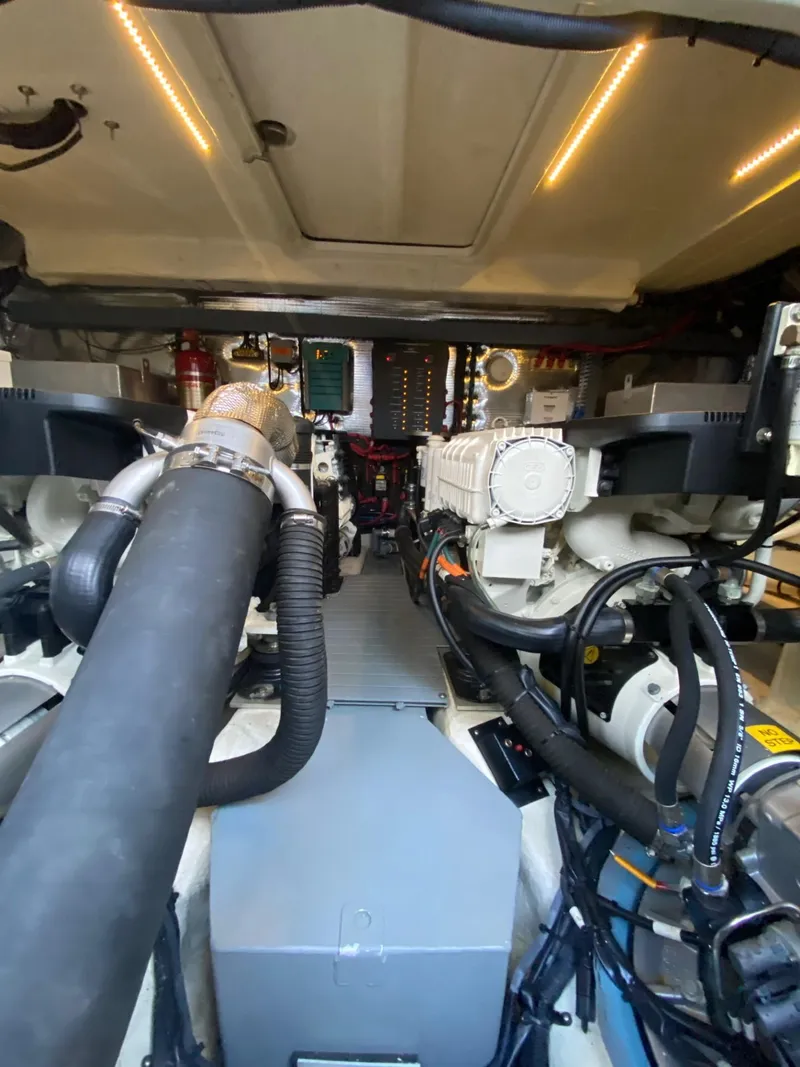 Slide: The Image of Engine room of 2018 Regal 42 Fly yacht, showcasing mechanical components and wiring. - 28