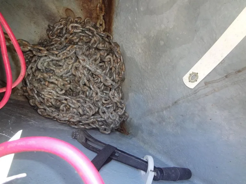 Slide: The Image of Anchor chain and cables in a 2000 Sea Ray 340 Sundancer boat compartment. - 11