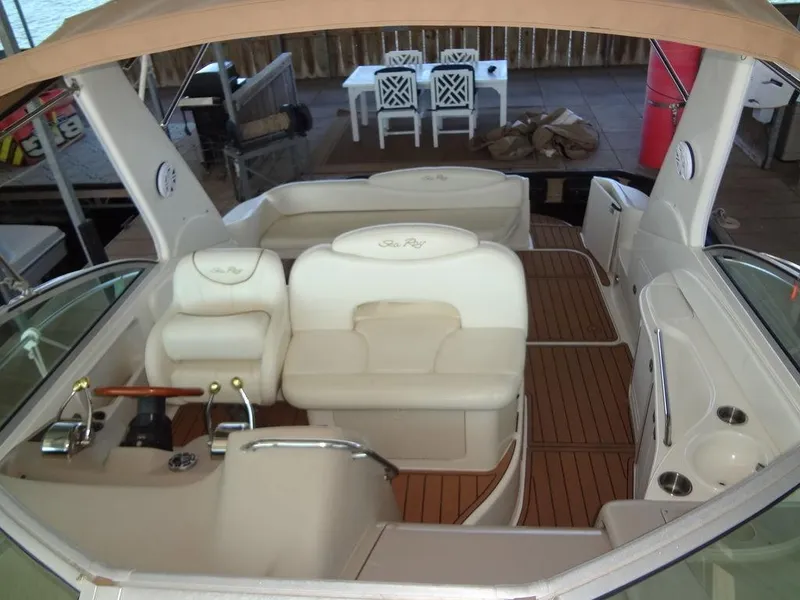 Slide: The Image of Interior of 2000 Sea Ray 340 Sundancer boat with white seating and wood flooring. - 14