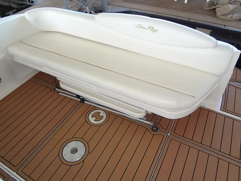 Slide: The Image of Sea Ray 340 Sundancer 2000 boat interior with white seating and teak flooring. - 17