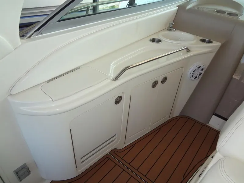 Slide: The Image of 2000 Sea Ray 340 Sundancer interior with sink and storage cabinets. - 20