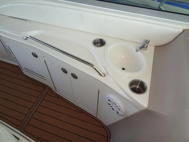 Slide: The Image of 2000 Sea Ray 340 Sundancer boat interior with sink and storage compartments. - 21