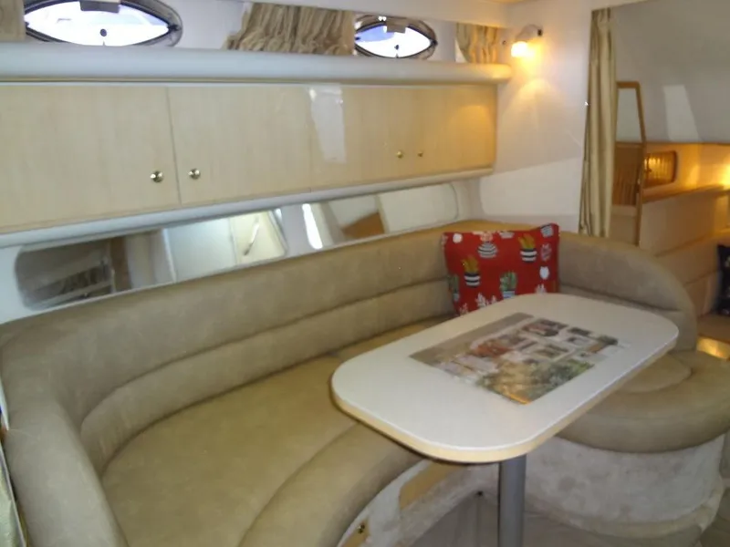 Slide: The Image of Interior of 2000 Sea Ray 340 Sundancer with beige seating and table. - 29