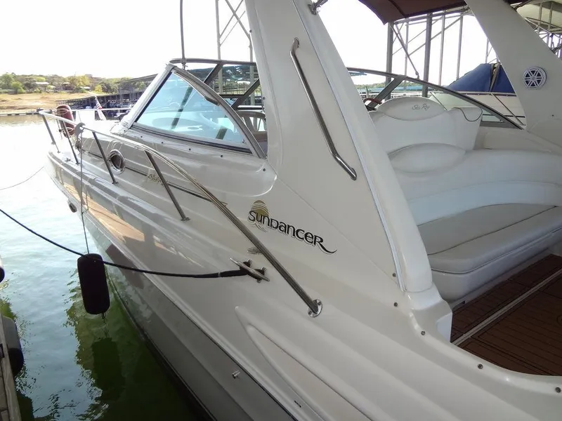 Slide: The Image of 2000 Sea Ray 340 Sundancer boat docked, showcasing sleek design and spacious seating. - 3